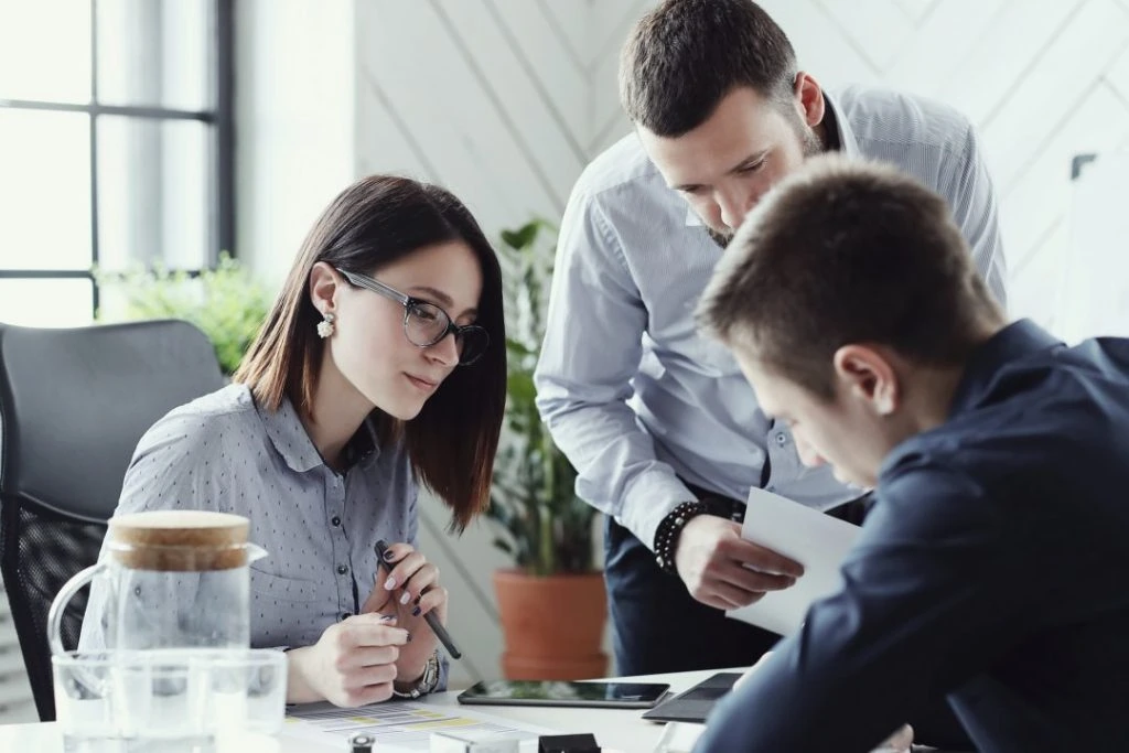 A group of business people working together in an office, specializing in tax return preparation.