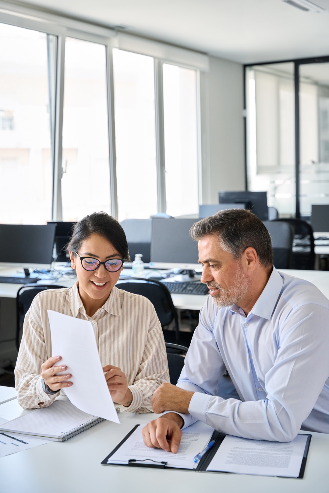 Two business people reviewing papers in an office for accounting services.